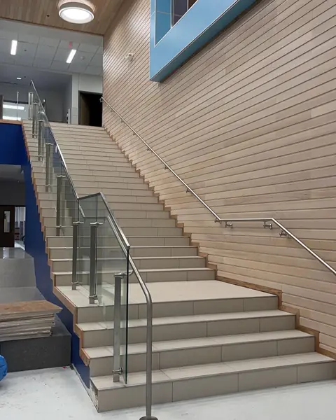 Glass stair guardrail and stainless wall handrail by Mobile Metal Services