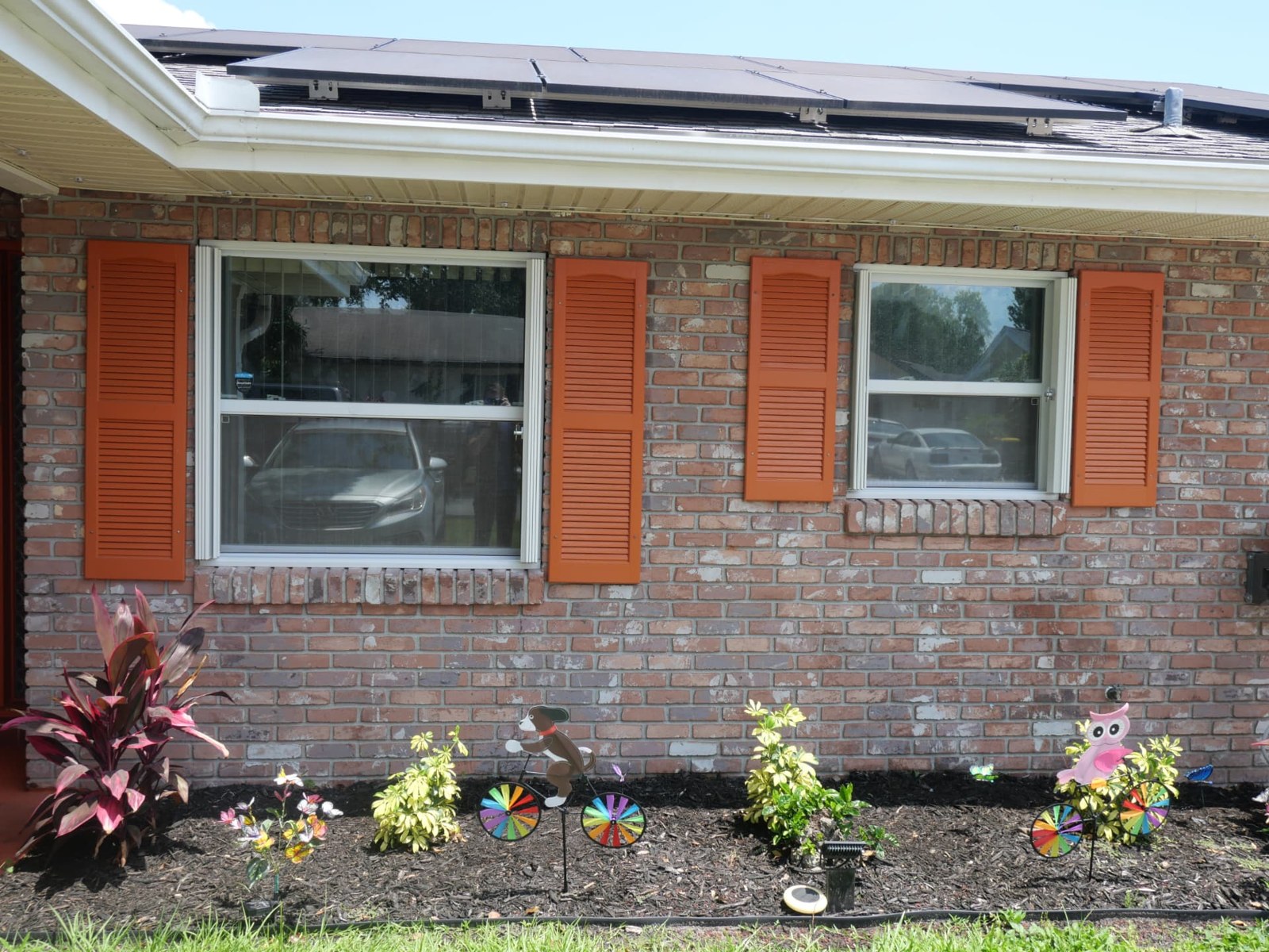 The same windows with accordion shutters retracted