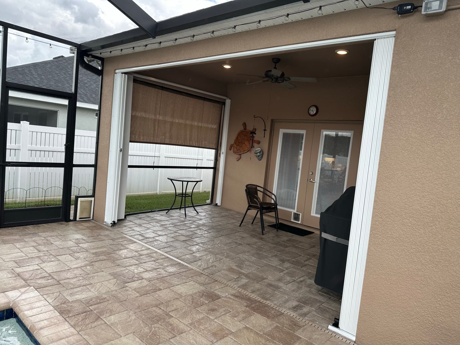 Patio opening with accordion shutters stacked at the sides
