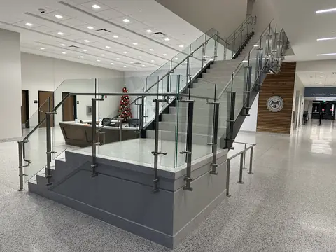 Architectural stainless railing around an interior staircase